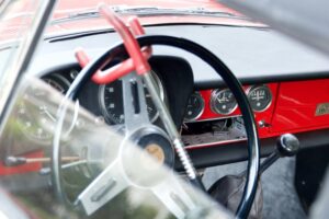 A steering-wheel lock installed across a vehicle steering wheel