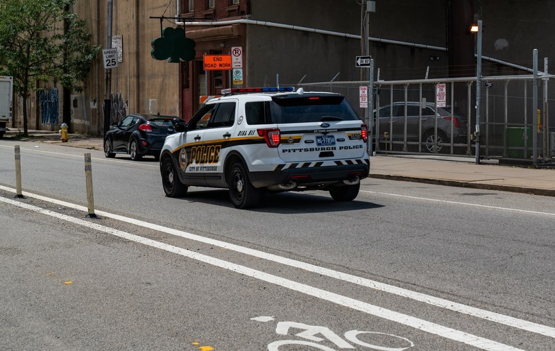 Marked Pittsburgh Bureau of Police vehicle traveling on Penn Avenue in the Strip District