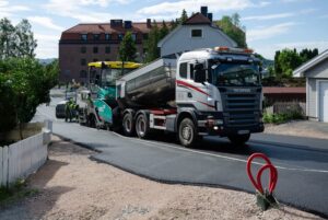 Road paving crew working with an asphalt paver