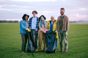Volunteers holding bags during a community litter cleanup